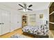 Bright bedroom featuring wood floors, ceiling fan, and a decorative floral bedspread at 6186 Oak Shore Dr, St Cloud, FL 34771