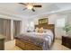 Relaxing main bedroom featuring tray ceiling, large bed, and soft, neutral colors at 6186 Oak Shore Dr, St Cloud, FL 34771
