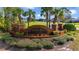 Brick Nova Bay community sign surrounded by manicured landscaping and palm trees at 6186 Oak Shore Dr, St Cloud, FL 34771