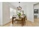 Cozy dining area with a wood table set with bench seating and a decorative light fixture at 6186 Oak Shore Dr, St Cloud, FL 34771