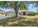 Charming one-story home with well-manicured lawn and mature tree in a desirable neighborhood at 6186 Oak Shore Dr, St Cloud, FL 34771