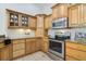 Spacious kitchen features granite countertops, stainless steel appliances, and custom wood cabinetry at 6186 Oak Shore Dr, St Cloud, FL 34771