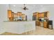 Spacious kitchen with wooden cabinets, granite countertops, and a breakfast bar at 6186 Oak Shore Dr, St Cloud, FL 34771