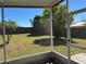 Backyard featuring a secure brick fence, lush lawn, and shaded areas with mature trees at 633 Cypress Tree Ct, Orlando, FL 32825
