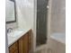 Tiled bathroom with a sink vanity, framed mirror, shower, and white countertop at 633 Cypress Tree Ct, Orlando, FL 32825