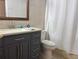 Bathroom featuring updated vanity, decorative mirror, and tiled shower at 633 Cypress Tree Ct, Orlando, FL 32825