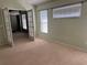 Bright bedroom featuring multiple windows, neutral carpet, and a set of french doors at 633 Cypress Tree Ct, Orlando, FL 32825