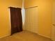 Bedroom features closet space and a sunny window with brown curtains at 633 Cypress Tree Ct, Orlando, FL 32825