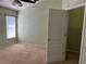 Bright bedroom with a large window, ceiling fan, beige carpet, and closet at 633 Cypress Tree Ct, Orlando, FL 32825