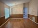 Spacious dining room featuring laminate floors, a chandelier, and a large window with natural lighting at 633 Cypress Tree Ct, Orlando, FL 32825