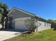 Well-maintained single-Gathering home with a two-car garage, green lawn, and tasteful landscaping at 633 Cypress Tree Ct, Orlando, FL 32825