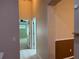 Hallway featuring beige tile flooring, neutral wall paint and open doorways to rooms at 633 Cypress Tree Ct, Orlando, FL 32825