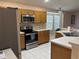Well-equipped kitchen featuring stainless steel appliances, tile flooring, and ample counter space at 633 Cypress Tree Ct, Orlando, FL 32825
