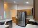Functional kitchen with stainless steel appliances, tile flooring, and neutral countertops at 633 Cypress Tree Ct, Orlando, FL 32825