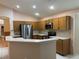 Stylish kitchen with stainless steel appliances, tile flooring, ample storage, and a breakfast bar at 633 Cypress Tree Ct, Orlando, FL 32825