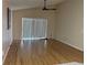 Bright living room features hardwood floors, ceiling fan, and sliding glass doors at 633 Cypress Tree Ct, Orlando, FL 32825