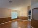 Spacious Living room featuring laminate floors, a chandelier, and a large window with natural lighting at 633 Cypress Tree Ct, Orlando, FL 32825