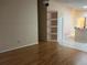 Spacious living room featuring hardwood floors and a built-in shelving unit at 633 Cypress Tree Ct, Orlando, FL 32825