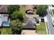 An overhead view shows a house with a pool, a well-maintained lawn, and mature trees around the property at 742 Chamberlin Trl, St Cloud, FL 34772