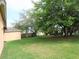 Well-manicured lawn with mature shade trees, providing a serene and private outdoor space at 742 Chamberlin Trl, St Cloud, FL 34772