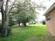 View of the large backyard with mature trees, offering plenty of space for outdoor activities at 742 Chamberlin Trl, St Cloud, FL 34772