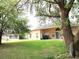 Spacious backyard featuring mature trees and a well-maintained lawn, perfect for outdoor activities at 742 Chamberlin Trl, St Cloud, FL 34772