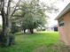 View of the large backyard with mature trees, offering plenty of space for outdoor activities at 742 Chamberlin Trl, St Cloud, FL 34772