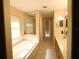 Bright bathroom with a soaking tub, glass-enclosed shower, and double vanity at 742 Chamberlin Trl, St Cloud, FL 34772