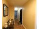 Bright hallway with hardwood floors and wall decor leading to other rooms of the home at 742 Chamberlin Trl, St Cloud, FL 34772