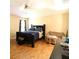 Main bedroom with hardwood floors, ceiling fan, and a cozy sitting area at 742 Chamberlin Trl, St Cloud, FL 34772