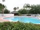 The community pool features clear blue water, lounge chairs, and mature palm trees, creating a relaxing atmosphere at 742 Chamberlin Trl, St Cloud, FL 34772