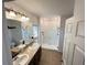Bright bathroom featuring a double sink vanity, walk-in shower, and great lighting at 939 Anna Pl, Davenport, FL 33837