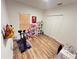 View of a bedroom featuring light walls, wood flooring, and a large closet at 939 Anna Pl, Davenport, FL 33837