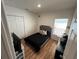 Bedroom featuring a bed, laminate flooring, window, and closet for storage at 939 Anna Pl, Davenport, FL 33837