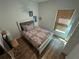 Bedroom featuring stylish decor, laminate flooring, a comfortable bed and natural light from the window at 939 Anna Pl, Davenport, FL 33837