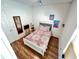 Bedroom with stylish decor, laminate flooring, and a comfortable bed with a patterned comforter at 939 Anna Pl, Davenport, FL 33837