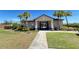 Attractive community entrance with palm trees, manicured lawn, and gated access to amenities at 939 Anna Pl, Davenport, FL 33837