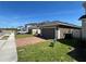 Single-Gathering home with a driveway, well-maintained lawn, and neutral color scheme against a clear blue sky at 939 Anna Pl, Davenport, FL 33837