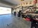 Open garage features concrete flooring and well-organized tool storage solutions, maintaining a clean appearance at 939 Anna Pl, Davenport, FL 33837