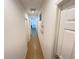 Image of the home's hallway with tile flooring and doors leading to the bedrooms at 939 Anna Pl, Davenport, FL 33837