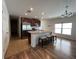 Bright kitchen with stainless steel appliances, island with seating, and decorative lighting at 939 Anna Pl, Davenport, FL 33837
