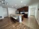 Bright kitchen with an island and seating features stainless steel appliances and tile floors at 939 Anna Pl, Davenport, FL 33837