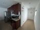 Modern kitchen featuring stainless steel appliances, dark wood cabinets, and granite countertops at 939 Anna Pl, Davenport, FL 33837