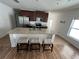 Open kitchen featuring a large island with seating and stainless steel appliances at 939 Anna Pl, Davenport, FL 33837