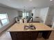Bright open-concept living space connecting the kitchen, dining area and living room with modern features at 939 Anna Pl, Davenport, FL 33837