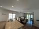 Bright open-concept living space connecting the kitchen with stainless steel appliances, dining area and living room at 939 Anna Pl, Davenport, FL 33837