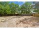 Large backyard surrounded by a privacy fence and mature trees at 9513 Bahia Rd, Ocala, FL 34472
