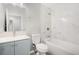 Updated bathroom with blue vanity, white tile shower, and modern fixtures at 9513 Bahia Rd, Ocala, FL 34472