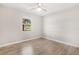 Bedroom featuring wood-look floors, neutral walls, and a window with natural light at 9513 Bahia Rd, Ocala, FL 34472