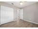 Bedroom featuring wood-look floors, a closet, and a doorway to an ensuite bathroom at 9513 Bahia Rd, Ocala, FL 34472